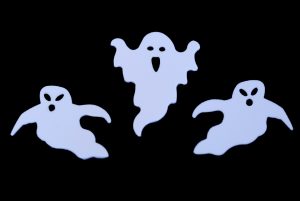 three white ghost outline shapes on black backdrop
